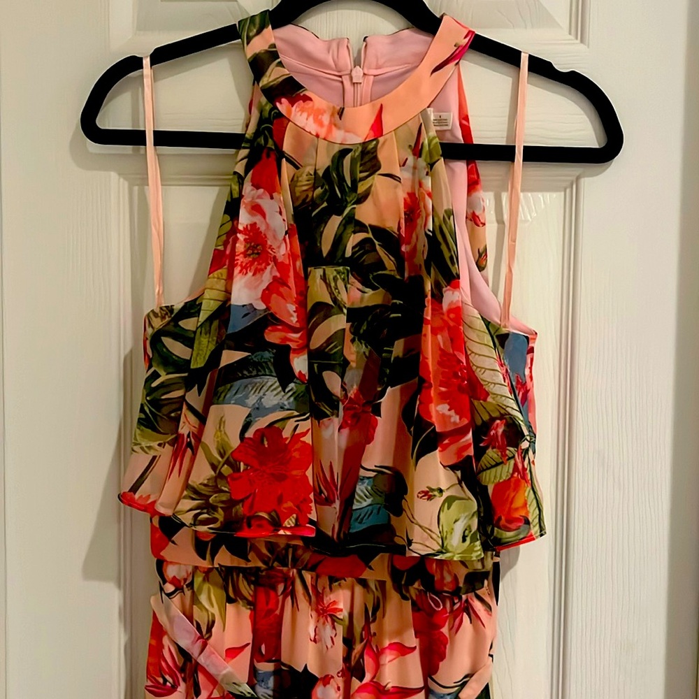 Eliza J flowy floral chiffon jumpsuit w matching evening purse.